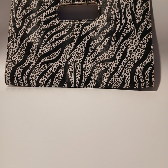 unbranded Handbags - Zebra Print Clutch. Magnetic Snap Closures.